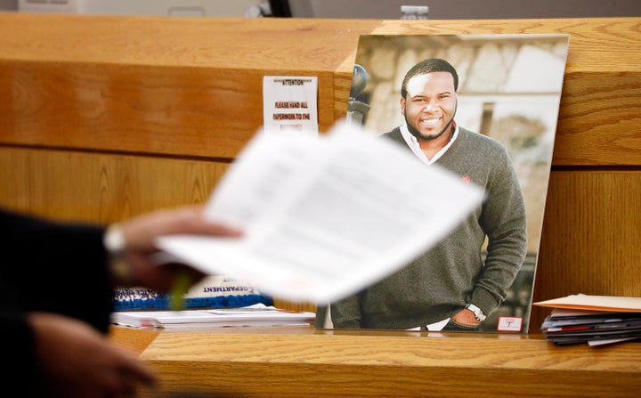 A photo of Botham Jean leans against Judge Tammy Kemp's bench during the murder trial of former Dallas police officer Amber G