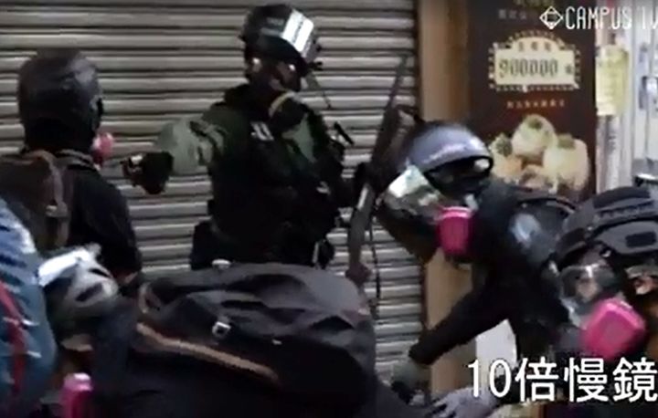 香港・新界地区で、警察がデモ参加者（左端）に実弾を発射する瞬間とされる映像＝香港大学学生会提供