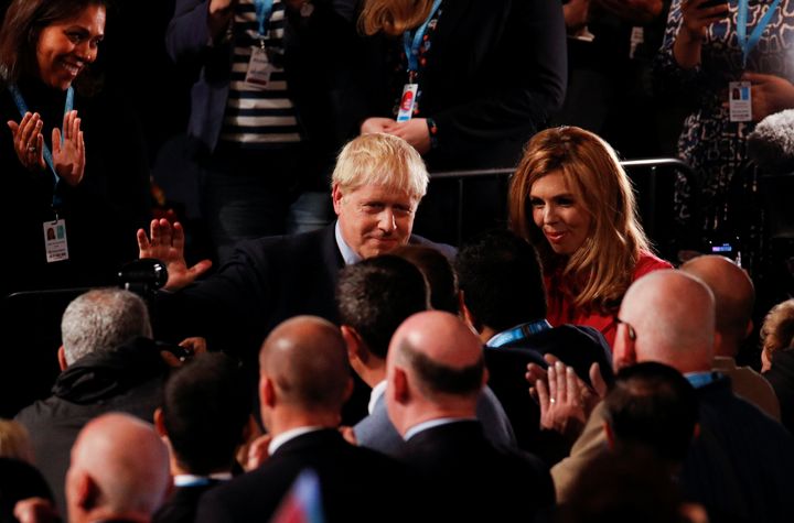 Johnson greets supporters, next to his partner Carrie Symonds, after his closing speech
