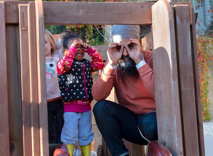 NDP Leader Jagmeet Singh and a young girl imitate the cameras as they stand on a play structure during a campaign stop at Hastings Park Childcare in Vancouver on Monday, Sept. 30, 2019. 