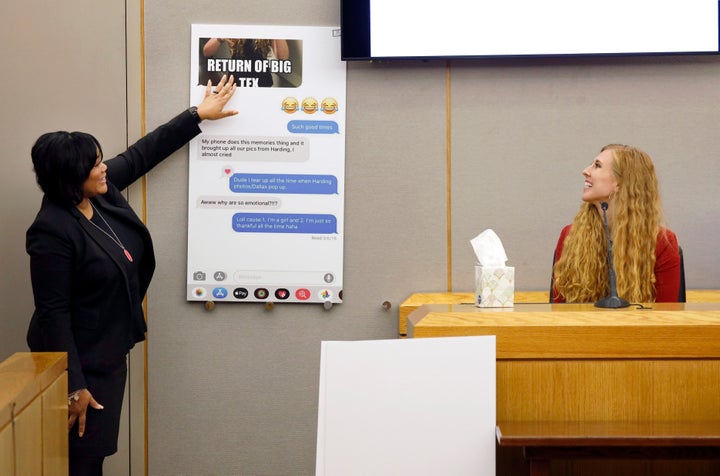 Assistant District Attorney LaQuita Long, left, shows a copy of a text message to Alexis Stossel, a close friend of Botham Jean, on the witness stand. Jean's nickname for Stossel, a tall Texan native, was "Big Tex."