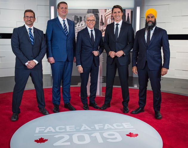 The federal leaders pose for a photo at the TVA french debate with host Pierre Bruneau for the 2019 federal election, in Montreal on Oct. 2, 2019.