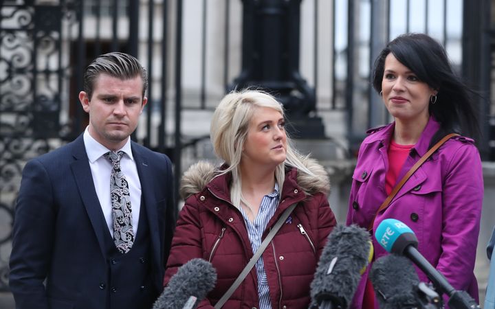 Sarah Ewart with solicitor Darragh Mackin (left) and Amnesty International Northern Ireland campaign manager, Grainne Teggart outside the High Court in Belfast.