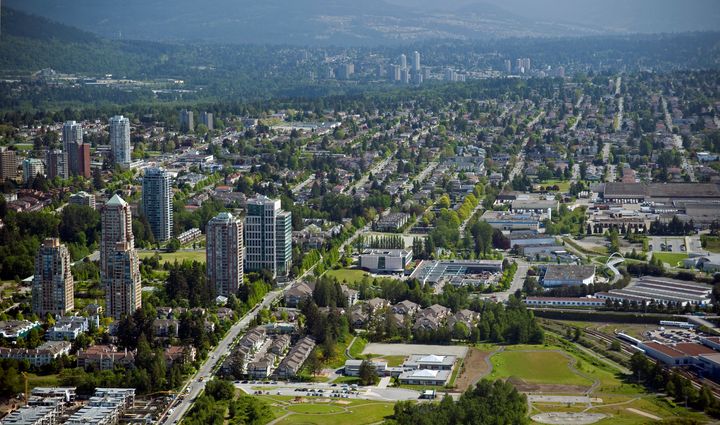 An aerial view of Burnaby, B.C., in the Greater Vancouver area, with New Westminster in the background.