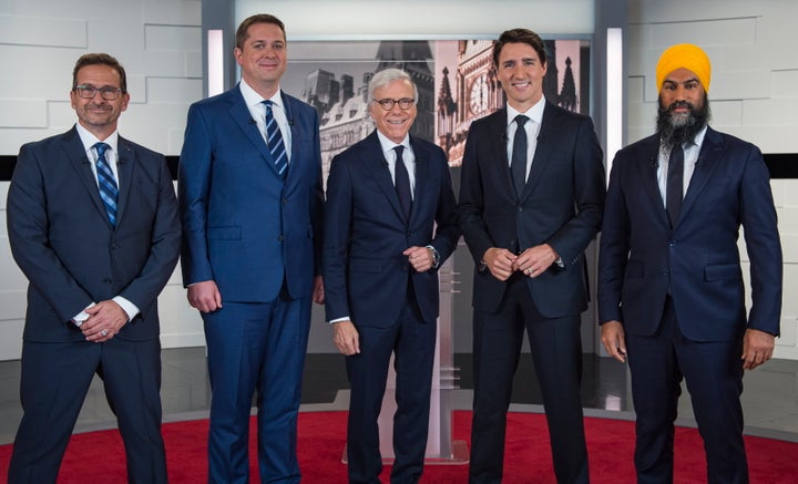 Leader of the Bloc Quebecois Yves-Francois Blanchet, left to right, Conservative Leader Andrew Scheer, TVA host Pierre Bruneau, Liberal Leader Justin Trudeau and NDP Leader Jagmeet Singh pose for a photo at the TVA french debate for the 2019 federal election, in Montreal on Oct. 2, 2019.