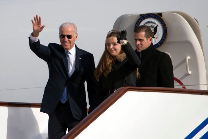 Then-Vice President Joe Biden, left, waves as he walks out of Air Force Two with his granddaughter Finnegan Biden and son Hunter Biden in 2012.