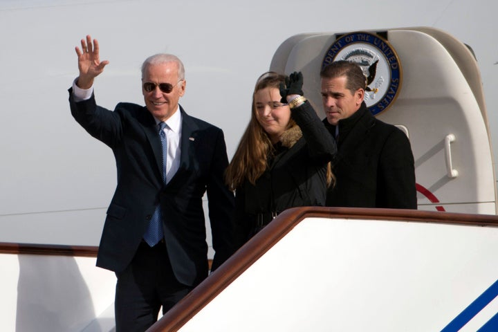Then-Vice President Joe Biden, left, waves as he walks out of Air Force Two with his granddaughter Finnegan Biden and son Hun