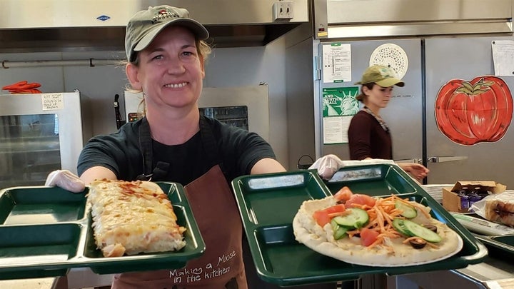 Portland, Maine, school cafeteria worker Alison Mason shows off lunch options at East End Community School, including traditi