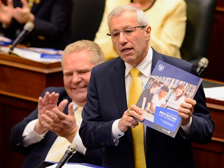 Former finance minister Vic Fedeli presents the 2019 budget as Premier Doug Ford looks on at the legislature in Toronto on April 11, 2019. 