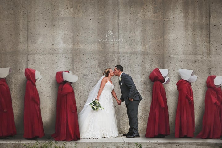 The photographers originally captioned this photo, "Praise be! ... As fans of the show, it only seemed fitting for there to be some Handmaids in K&T's wedding photos along the 'hanging wall' in Mill Race Park!"