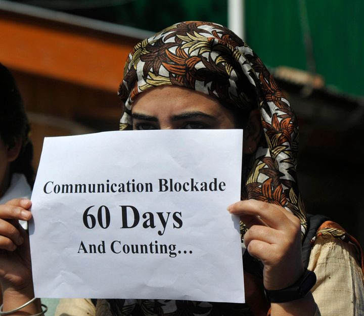 A Kashmiri journalist holding a poster to protest against the communication blockade on October 3, 2019 in Srinagar. 