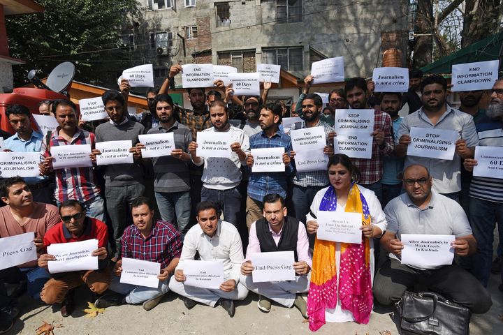 Kashmiri journalists holding posters to protest against the communication blockade on October 3, 2019 in Srinagar.