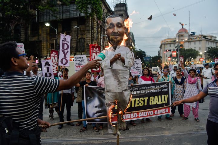 Protesters burn an effigy of expelled BJP leader Kuldeep Sengar. 