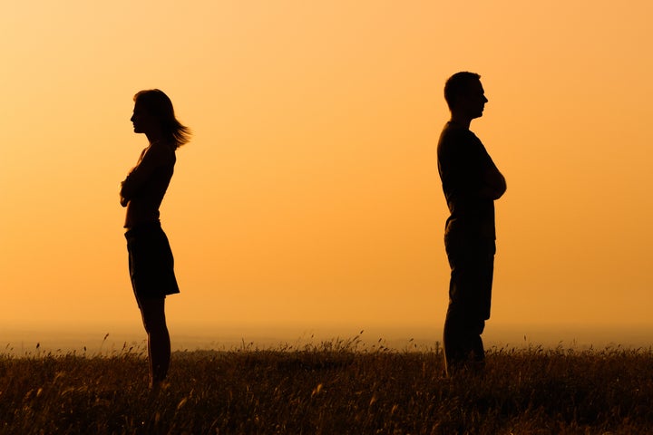 Silhouette of a angry woman and man on each other.