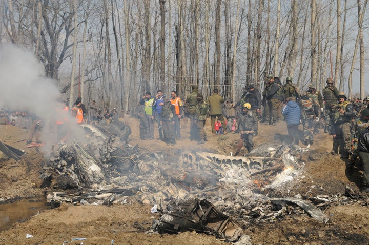 Paramilitary personnel stand near the wreckage of an Indian Air Force helicopter after it crashed on February 27, 2019 in Budgam, India.