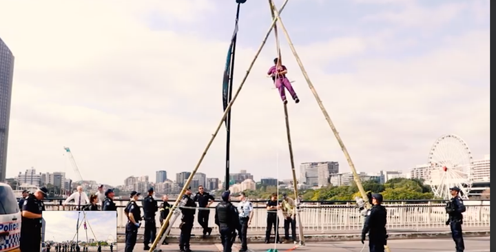 XR south east Queensland member Sophie Thompson dangles from a makeshift tripod on Brisbane's Victoria Bridge. The protest shut down Brisbane's CBD on Monday, the start of a string of demonstrations across Australia for October. 