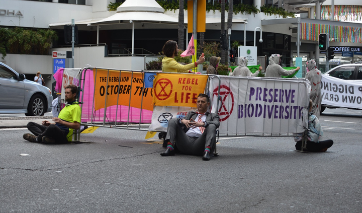 Brisbane's second major protest saw a major road blocked in peak hour. Activists locked themselves onto fencing with a combination of bike locks and super glue.