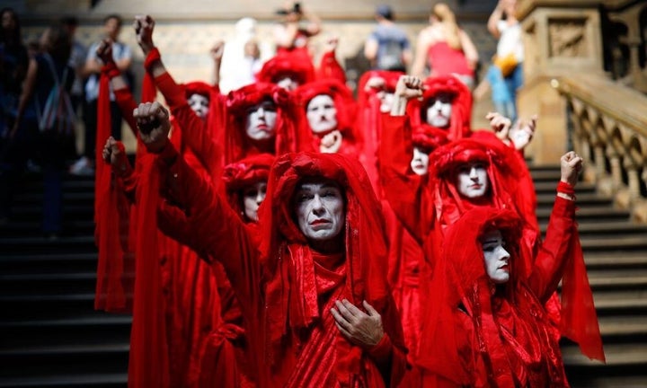 Extinction Rebellion activists at London's Natural History Museum in April. XR has confirmed the Red Rebels will be in Sydney for International Rebellion Week. 