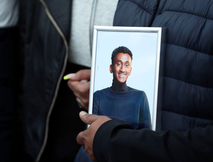 Chandima Daniel, father of Tashan Daniel, who was stabbed at Hillingdon station whilst on his way to an Arsenal game on Tuesday, holds a photograph of him at a vigil held outside the underground station in London.