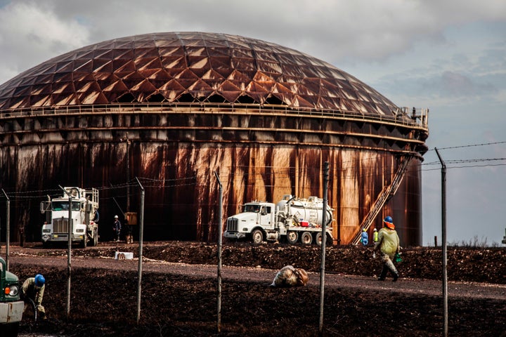 Workers clean up the oil spill at an Equinor storage facility along Grand Bahama&rsquo;s southeast coast in September 2019.