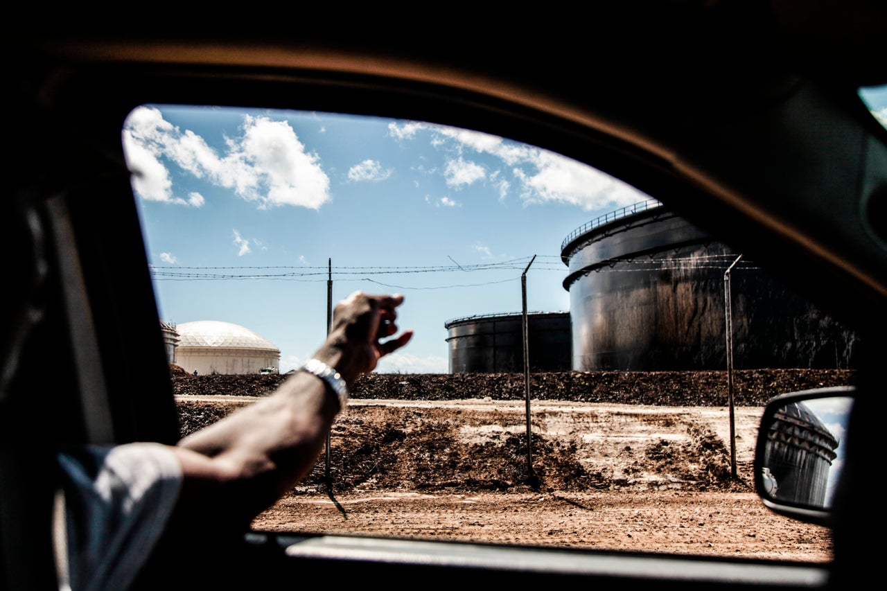 A resident points out the tanks covered in oil. 