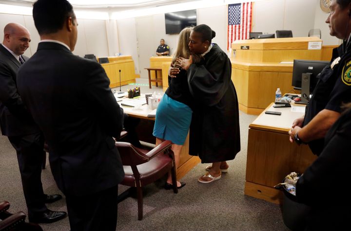 Amber Guyger and Judge Tammy Kemp hug after the judge gave the convicted murderer a Bible after the case ended.