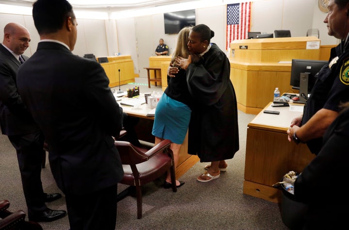 Amber Guyger and Judge Tammy Kemp hug after the judge gave the convicted murderer a Bible after the case ended.