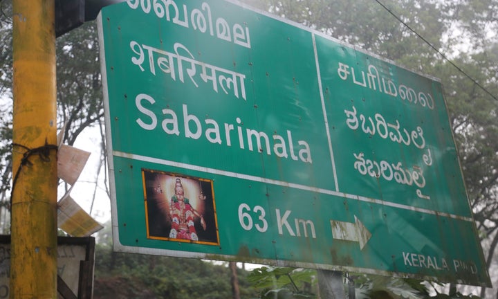 Road sign showing the distance to the Sabarimala temple in Kerala, India.