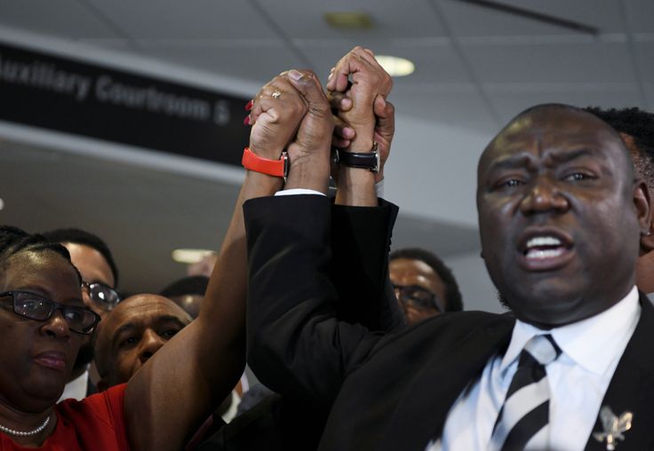 Botham Jean's mother, Allison Jean, and his father, Bertram Jean, raise their hands with their family attorneys Daryl Washington, Benjamin Crump and Lee Merritt after Guyger's murder conviction was delivered on Oct. 1, 2019.
