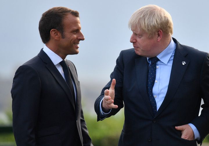 French President Emmanuel Macron speaks with Prime Minister Boris Johnson at the official welcome during the G7 summit in Biarritz, France.