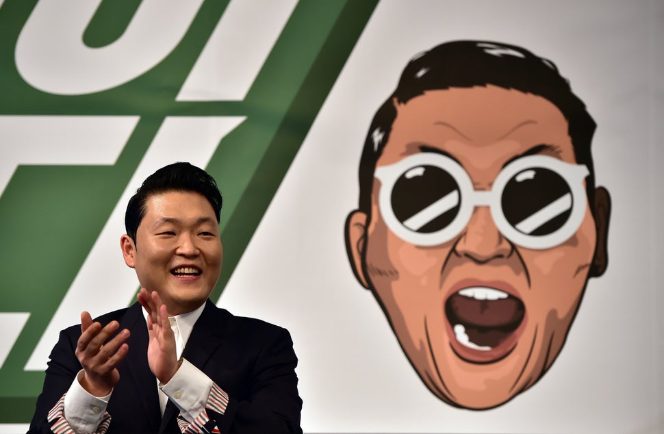 South Korean singer Psy, 37, applauds during a press conference to promote his seventh album at a hotel in Seoul on November 30, 2015. 