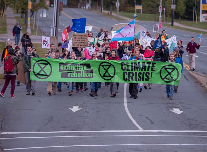 Protesters from the Extinction Rebellion group march towards the Angus L. Macdonald Bridge in Dartmouth, N.S., on Monday demanding action on climate change. 