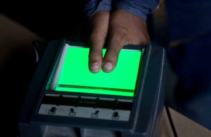 A boy gives his thumb impressions at a National Register of Citizens (NRC) office on the eve of the release of the final NRC draft in Gauhati, India, Friday, Aug. 30, 2019.