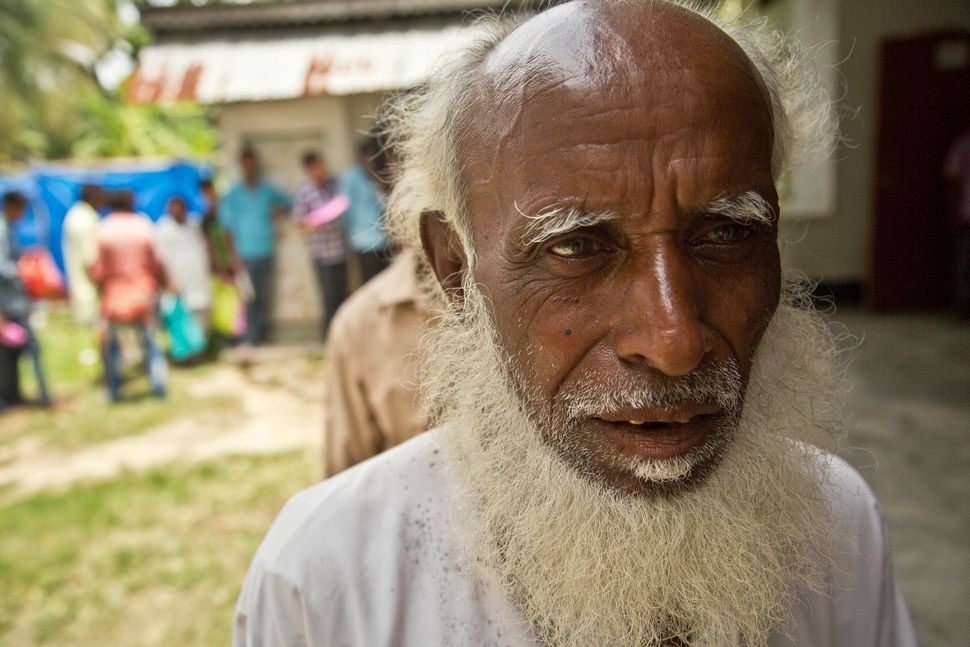 An elderly man, whose name did not appear in the National Register of Citizens (NRC) draft, stands in a queue to collect forms to file appeals in Mayong, 45 kilometers (28 miles) east of Gauhati, India, Friday, Aug. 10, 2018. 