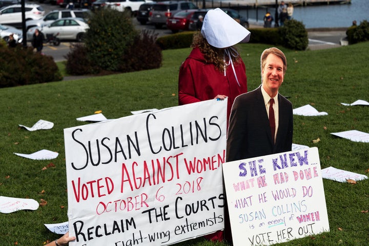 A protester in Maine holding a cut-out of Supreme Court Justice Brett Kavanaugh.