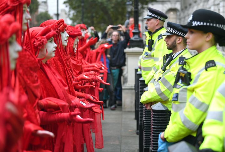 Protesters, dubbed the Red Rebels, outside the Cabinet Office on Whitehall, during an Extinction Rebellion (XR) protest in Westminster, London.