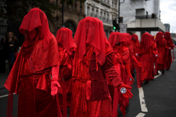 Climate activists take part in a demonstration at Whitehall, in London, Monday, Oct. 7, 2019. 