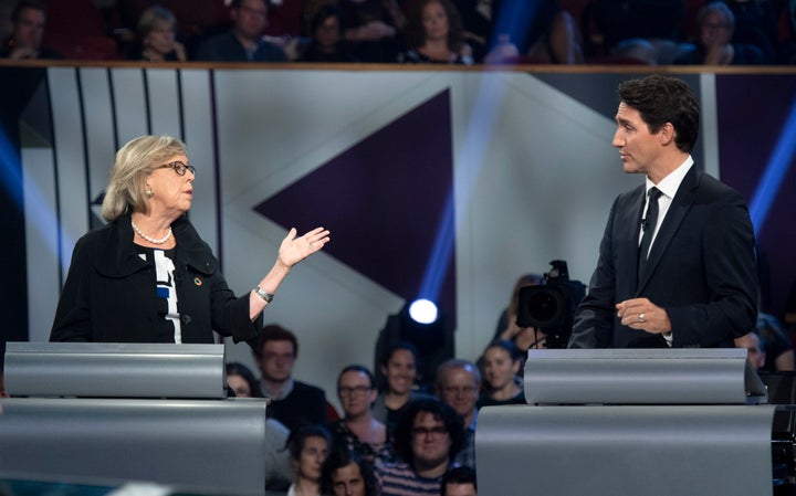 Green Party Leader Elizabeth May and Liberal Leader Justin Trudeau gesture to each other as they both respond during the federal leaders' debate in Gatineau, Que. on Oct. 7, 2019.