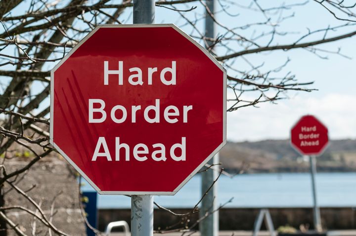Sign at a stop junction in Ireland saying "Hard Border Ahead"