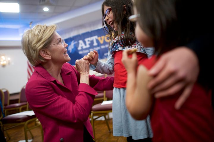 Democratic presidential hopeful Elizabeth Warren pinky-swears with Rebecca Buse-Morley, 8, at a May 13 American Federation of Teachers event.