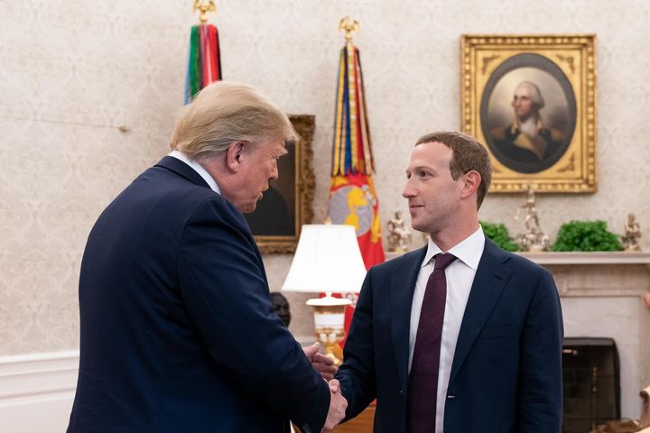President Donald Trump shakes hands with Facebook CEO Mark Zuckerberg.