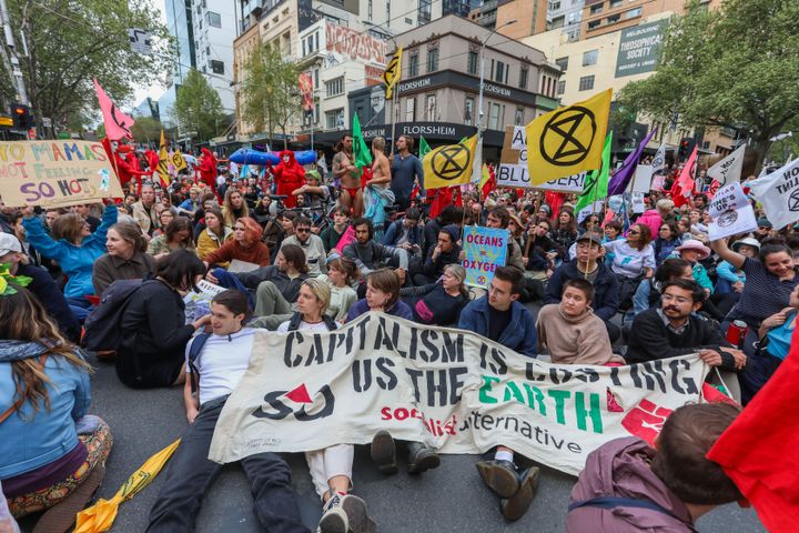 Demonstrators stage a sit-in on a road during an Extinction Rebellion protest in Melbourne on Monday.
