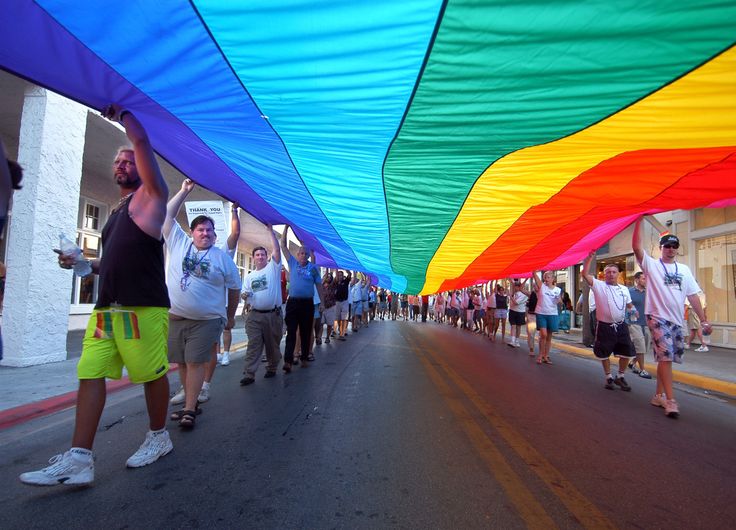 Participants walk with a 100-foot rainbow flag during the Hillsborough Pride in Exile weekend celebration Aug. 13, 2005, in Key West, Florida.