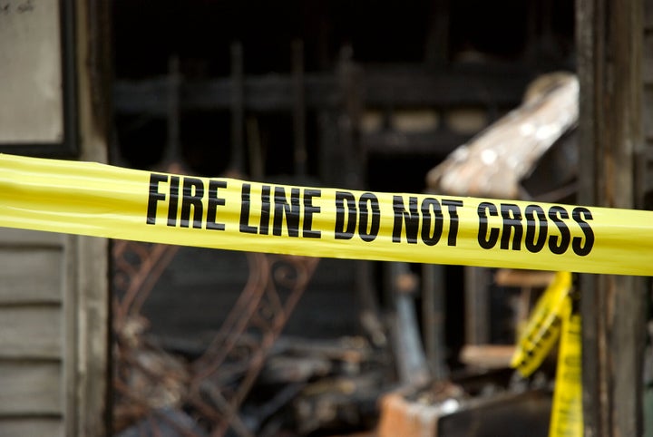 Fire line in front of a destroyed home.