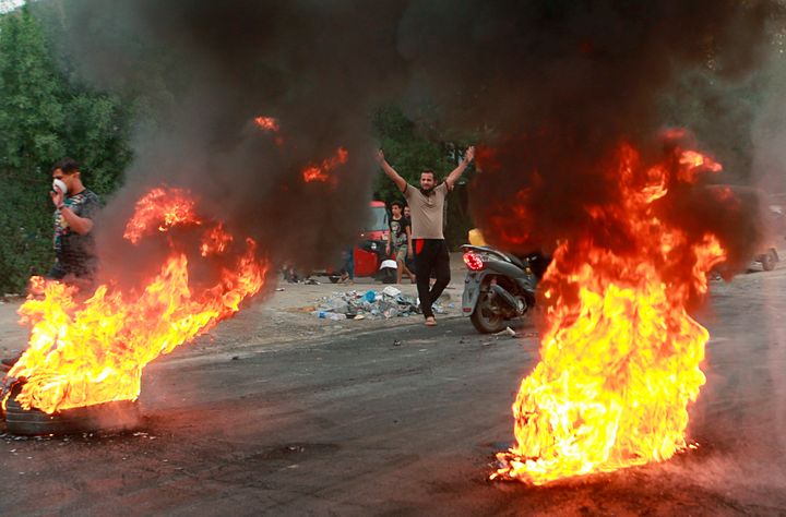 Anti-government protesters set fires and close a street during a demonstration in Baghdad, Iraq. The protests have plunged the country into a new cycle of instability since last week, one that could potentially be the most dangerous this conflict-scarred nation has had to face, with more than 100 killed in less than a week. Iraqi security forces have been shooting at young Iraqis demanding jobs, electricity and clean water and an end to corruption. (AP Photo/Khalid Mohammed, File)