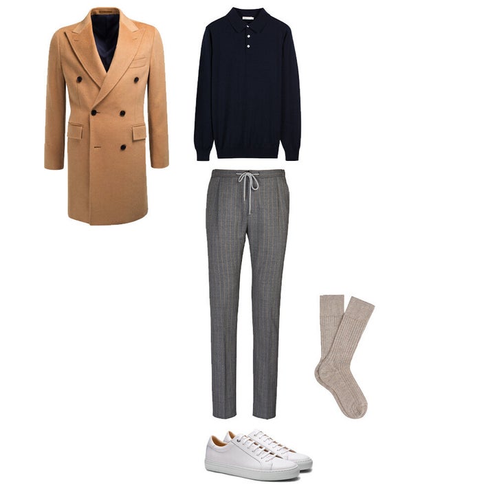 Men's camel coat, long-sleeve navy polo, drawstring wool trousers and white sneakers, all by Suit Supply.