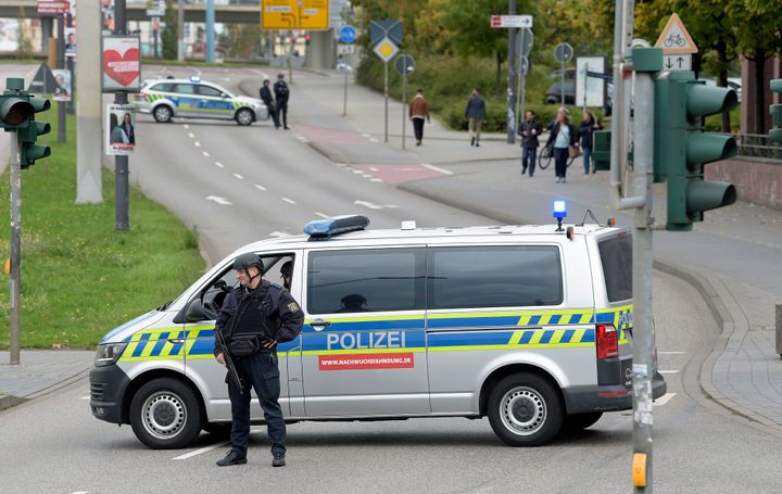 Police officers block a road in Halle, Germany, Wednesday, Oct. 9, 2019. One or more gunmen fired several shots on Wednesday in the German city of Halle. Police say a person has been arrested after a shooting that left two people dead. (AP Photo Jens Meyer)