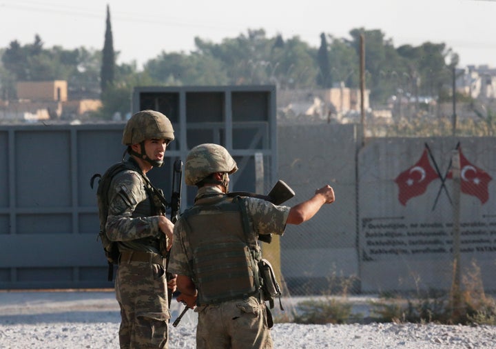Shortly after the Turkish operation inside Syria had started, Turkish soldier stand at the border with Syria in Akcakale, San