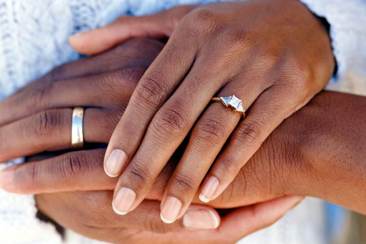 Hands of married couple wearing wedding rings