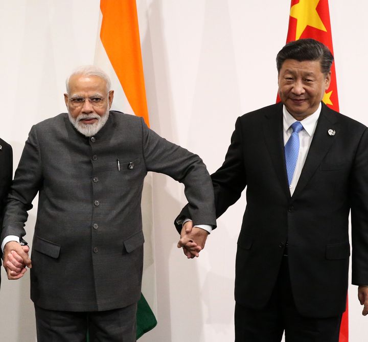 Prime Minister Narendra Modi and Chinese President Xi Jinping pose for a group photo prior to their trilateral meeting at the G20 Osaka Summit 2019 on June 28, 2019 in Osaka, Japan. 